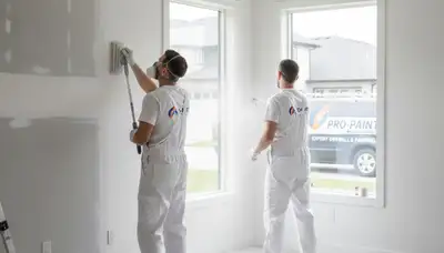 Painter repairing drywall cracks in Dallas, TX home interior for House Painters Dallas service page